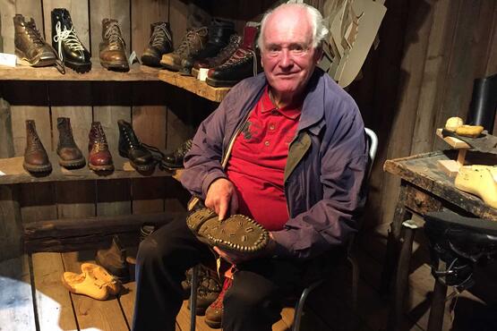 Otto Burgener made hundreds of pairs of mountain boots and ski boots over his lifetime. He points out the 